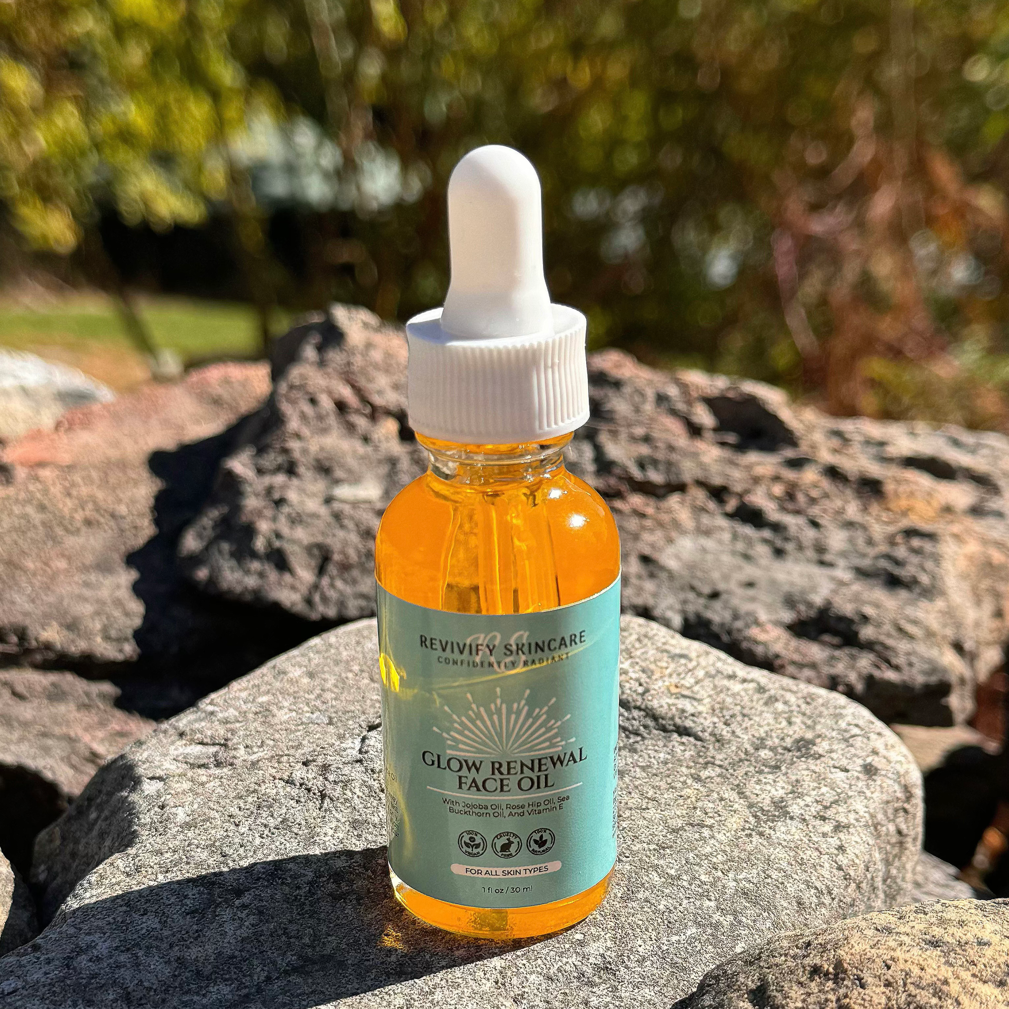 Glow Renewal Face Oil in a dropper bottle on rocks, showcasing its nourishing and hydrating properties.