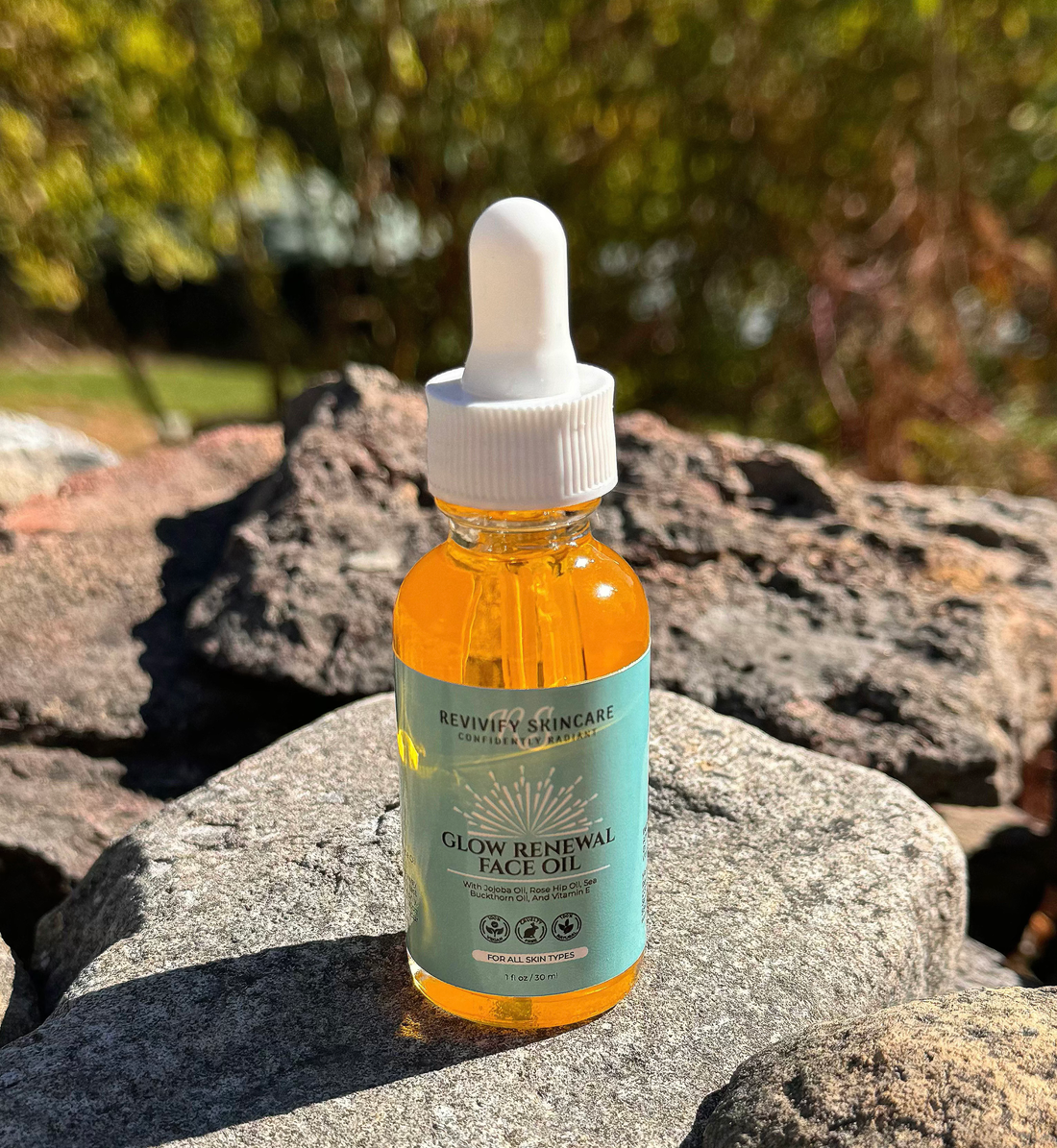 Glow Renewal Face Oil in a dropper bottle on rocks, showcasing its nourishing and hydrating properties.