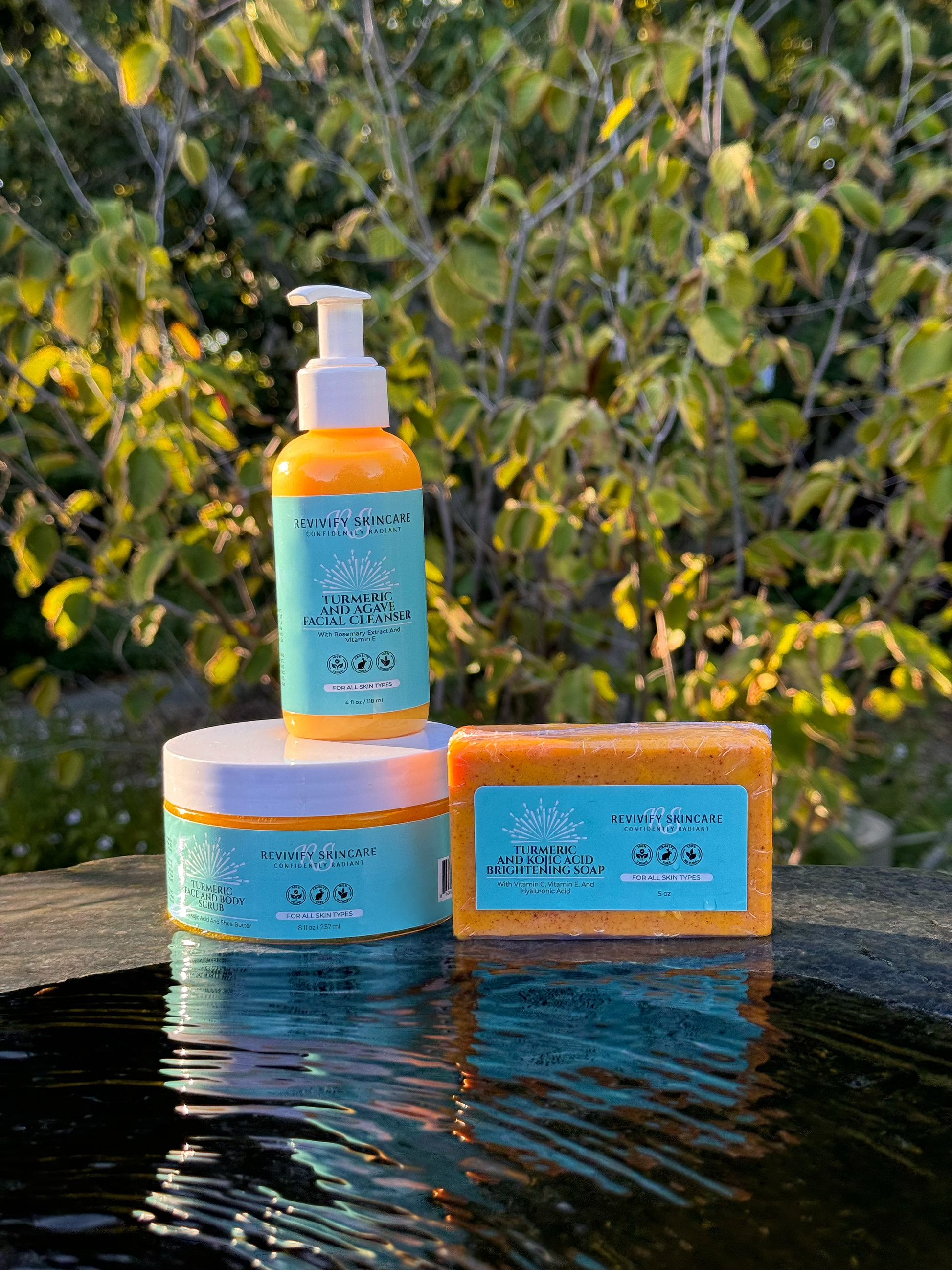 Turmeric skincare bundle with bar soap, cleanser, and scrub against a natural backdrop for glowing skin benefits.